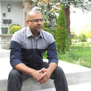 Faisal Kutty sitting
